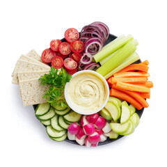 Healthy food plate with various raw vegetables, diet crispbreads and hummus, top view