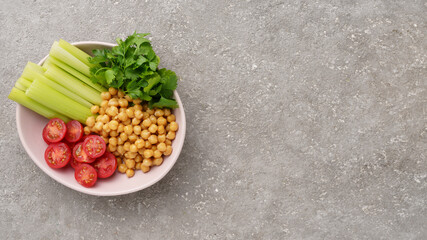 Healthy food plate with various raw vegetables and boiled chickpeas, vegetarian food, top view