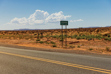 Arizona state line sign in the landscape near Monument Valley