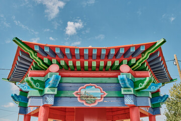 Old wooden roof of gazebo for buddhist ritual drum, with colorful decor, Buryatia, Russia