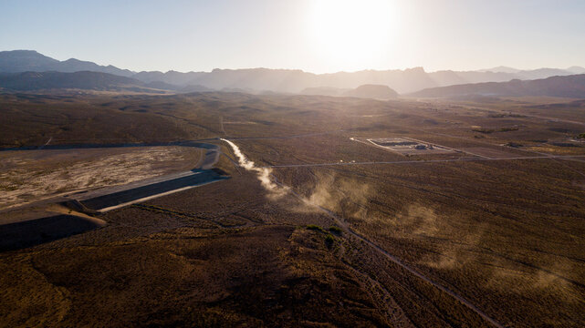 Aerial view of arid landscape against clear sky during sunny day - Powered by Adobe