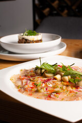 Fish carpaccio. Finely sliced ​​fish. Tuna and needle fish. Garnished with Olive Oil and Capers