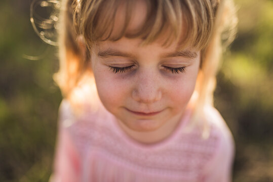 Close up portrait of young girl with eyes closed