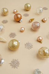 Christmas baubles, balls, ribbons, stars on beige background