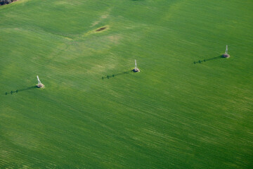 Aerial view of a high-voltage power line crossing a farm field near Brevard, NC