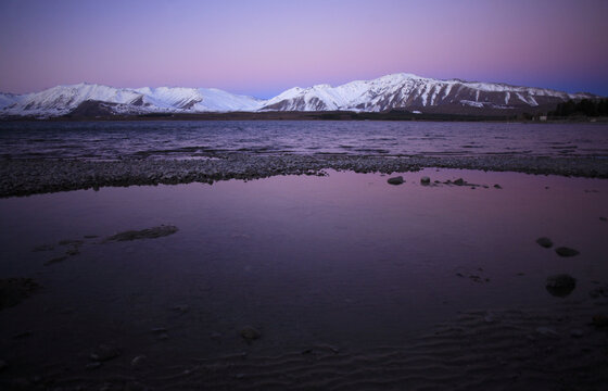 Lake Tekapo, New Zealand, and twilight, with snow capped mountains