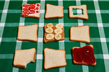 Fruit or jam. Original composition with uncooked bread toasts on plaid green and white tablecloth background. Vintage, retro style. Food pop art photography.