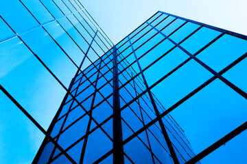 Business Building with Glass Windows Reflecting Blue Sky