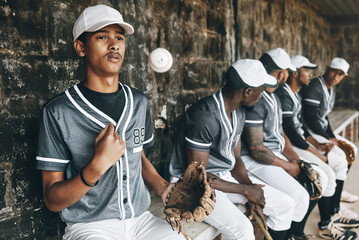 Baseball, sports and team with a man athlete thinking about the match or game while sitting in the dugout. Exercise, fitness and idea with a male baseball player group ready to play in a match