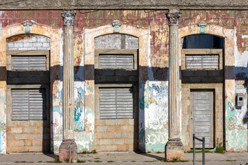 Three doors in an old wall with columns