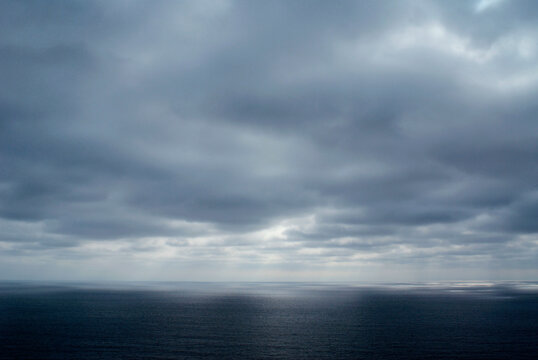 grey clouds hug the coast of Blacks Beach, San Diego, California