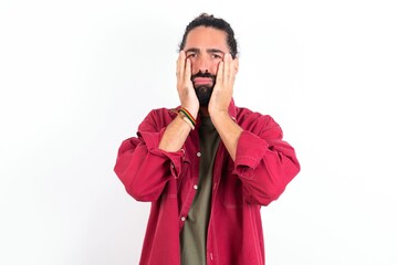 Caucasian man with beard wearing red shirt over white background Tired hands covering face, depression and sadness, upset and irritated for problem