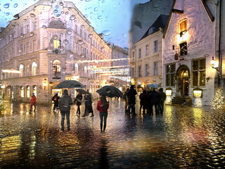  Rain in   medieval city street people with umbrella walk on road crossing buildings urban lifestile rainy season weather forecast Tallinn old town 
