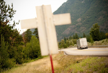 A white cross signifying a death along a dangerous highway.