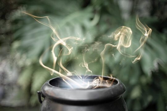Halloween witchcraft background. The witch is casting a spell. witch make magical potion with a magic wand and magic lights. Halloween celebration,