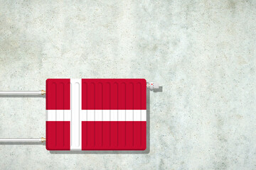 Heating battery, in the colors of the Danish flag on a concrete wall. Copy space. Raising heating prices. Heat saving. Energy crisis.
