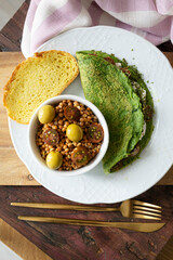 Spinach pancakes with cheese and cherry tomatoes with lentil salad. Ready-to-eat vegetarian food
