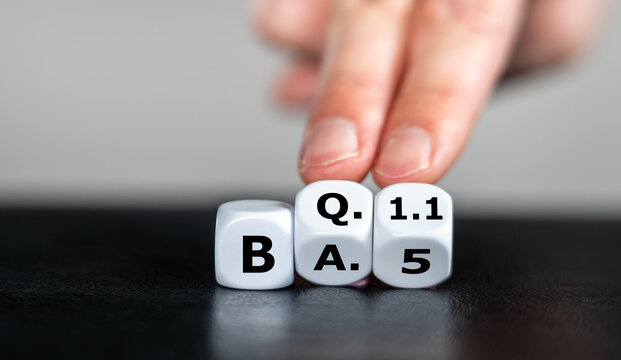 Symbol for a new corona virus mutant. Hand turns dice and changes the expression 'BA.5' to 'BQ.1.1'.