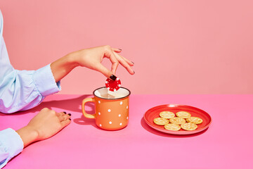 Your bets. Food pop art photography. Young girl tasting milk with crackers isolated over pink...