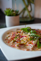 Fish carpaccio. Finely sliced ​​fish. Tuna and needle fish. Garnished with Olive Oil and Capers
