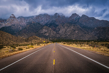 The entrance road to the Sandia Peak Tramway with dramatic snow and clouds in Albuquerque, New...