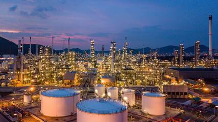Aerial view oil storage tank and oil refinery factory plant at night form industry zone, Oil...