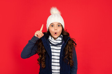 inspired with idea kid with curly hair in hat. teen girl on red background.