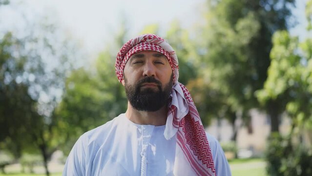 Portrait of confident Arab man in traditional middle-eastern clothing outdoors