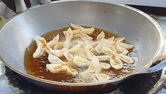 Indonesia food frying batagor on a roadside cart
