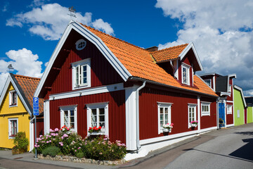 Fototapeta na wymiar Colorful wooden houses in Bjorkholmen, the oldest district of Karlskrona, Sweden