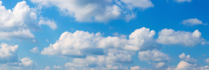 Obraz na płótnie Canvas Sunlit white clouds in the blue sky