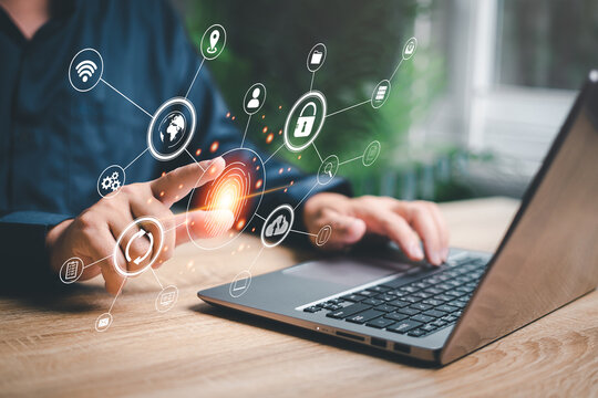 Fingerprint scanning and biometric authentication,Businessman Fingerprints on virtual screens use laptop  processing of biometric for access personal security data scanning of digital programs