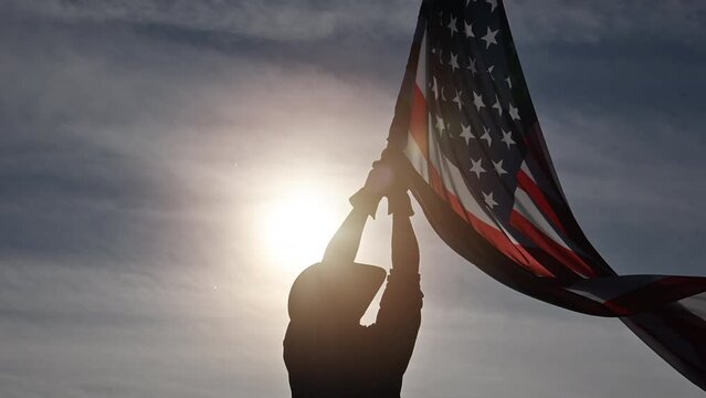 Man Shows Love of Country by Waving American Flag