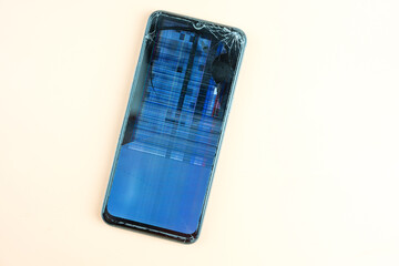 Glass smartphone display with cracks close up. Broken glass on a cell phone. A gadget that has become unusable due to a fall.