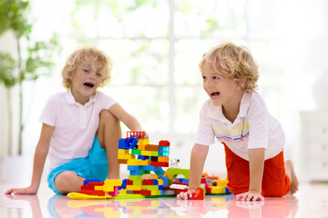 Child playing with toy blocks. Kids play.