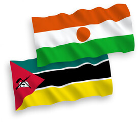 National vector fabric wave flags of Republic of the Niger and Republic of Mozambique isolated on white background. 1 to 2 proportion.
