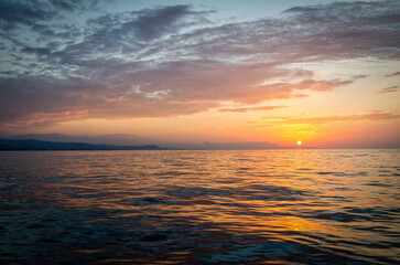 Naklejka na ściany i meble Greek summer sunset with sea water reflection