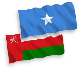 National vector fabric wave flags of Sultanate of Oman and Somalia isolated on white background. 1 to 2 proportion.