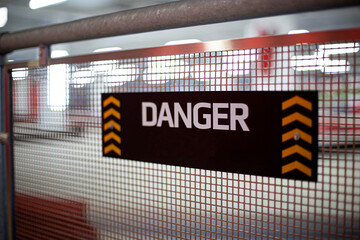 danger sign on chain link fence