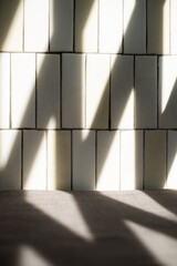 A shadow and light pattern on a cement wall. Concept of construction, creative, decorative, element, studio light. A silhouette background textured composition.