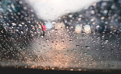 Select focus. Rain drop on windshield. Driver slow down on the road in the evening, no drinks...