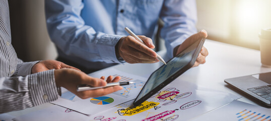 Young colleagues discussing business and price chart analyzes business people on the table great in...