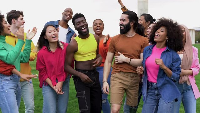 Multiracial people dancing at city park
