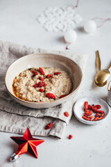 Breakfast porridge oats topped with fruit nuts and seeds