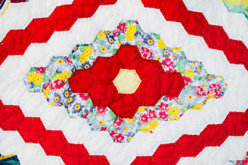Close up of a bright and colorful diamonds and hexagon quilt