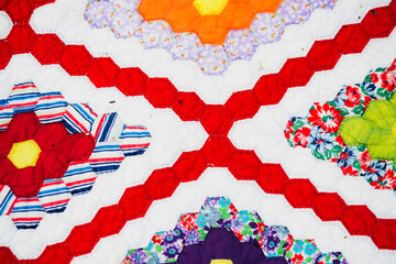 Close up of a bright and colorful diamonds and hexagon quilt
