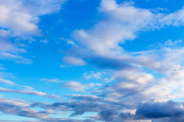 Fototapeta na wymiar Dark and white fluffy clouds in the blue sky