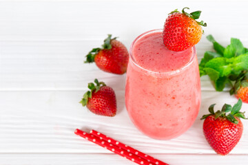Strawberry yogurt fruit juice smoothie pink colorful fruit juice milkshake blend beverage healthy high protein the taste yummy In glass drink episode morning on white wood background.