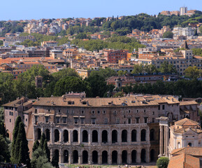 Obraz premium The Theatre of Marcellus (Teatro Marcello)in Italy, the largest open-air theatre in Ancient Rome. On the right the ruins of Temple of Apollo Sosianus.