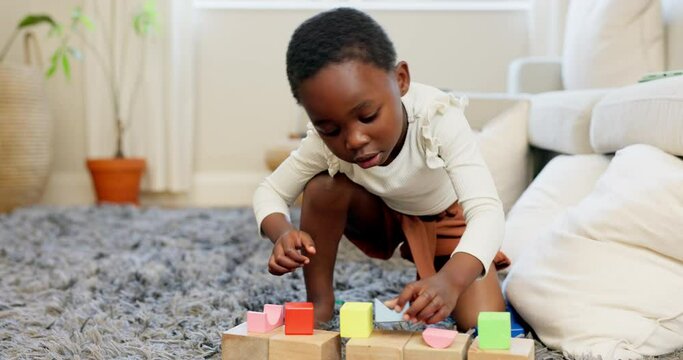 Black girl, building blocks and creative learning in family home lounge, growth and fun development. Happy african kids, educational brick toys and wood puzzle, montessori play and living room game